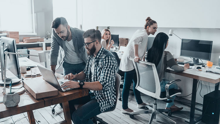 image of an office with people working