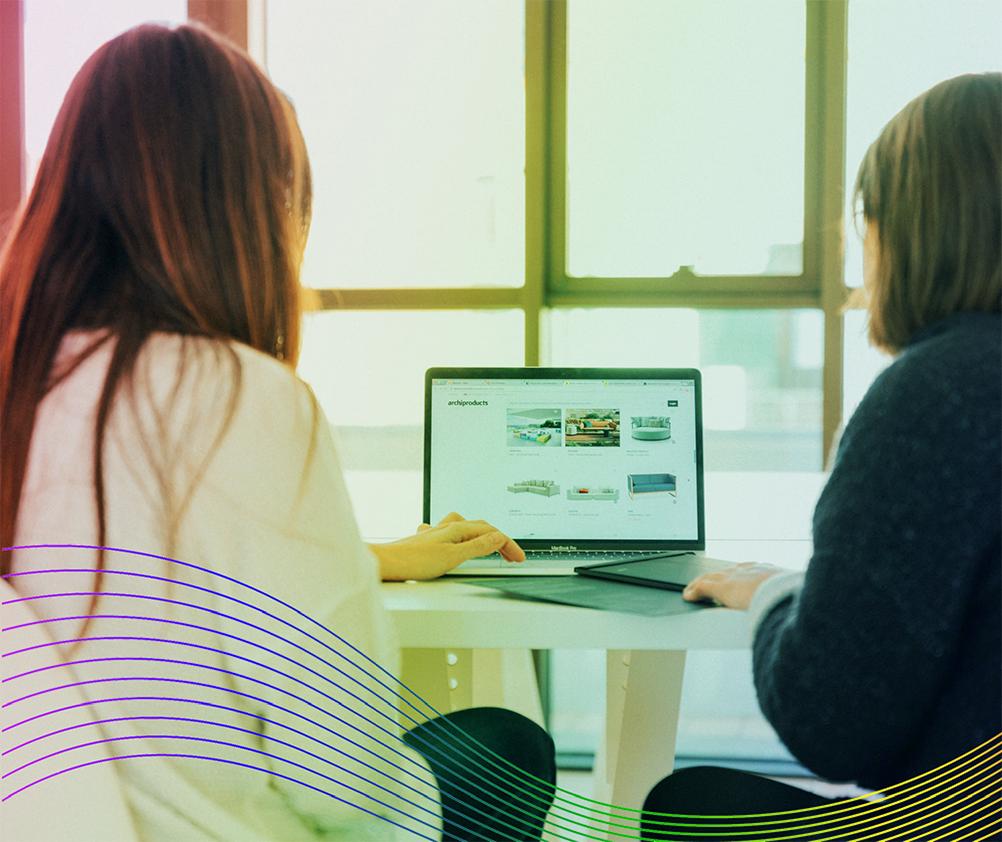 two women working on a laptop