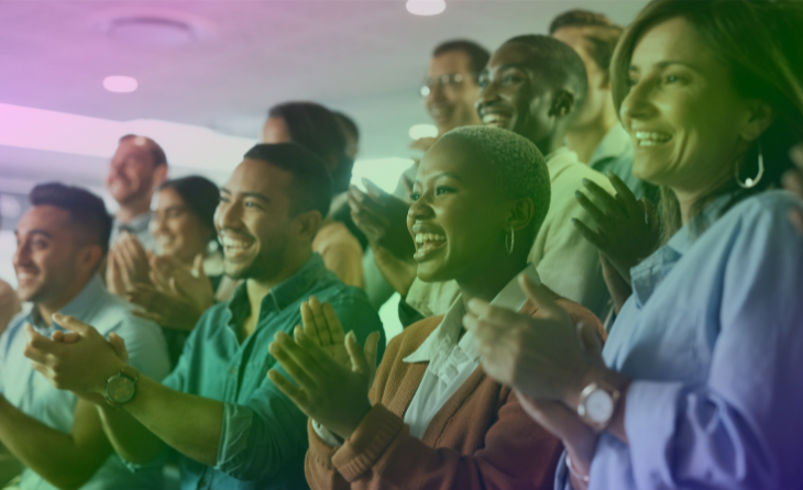 Diverse group of people clapping and smiling in celebration of ISO 50001 certification.